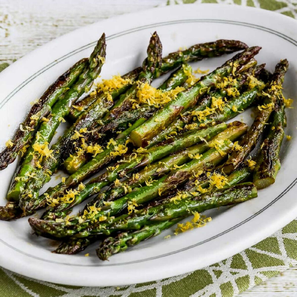 Square image of Fried Asparagus with Lemon Juice and Lemon Zest, shown on serving platter