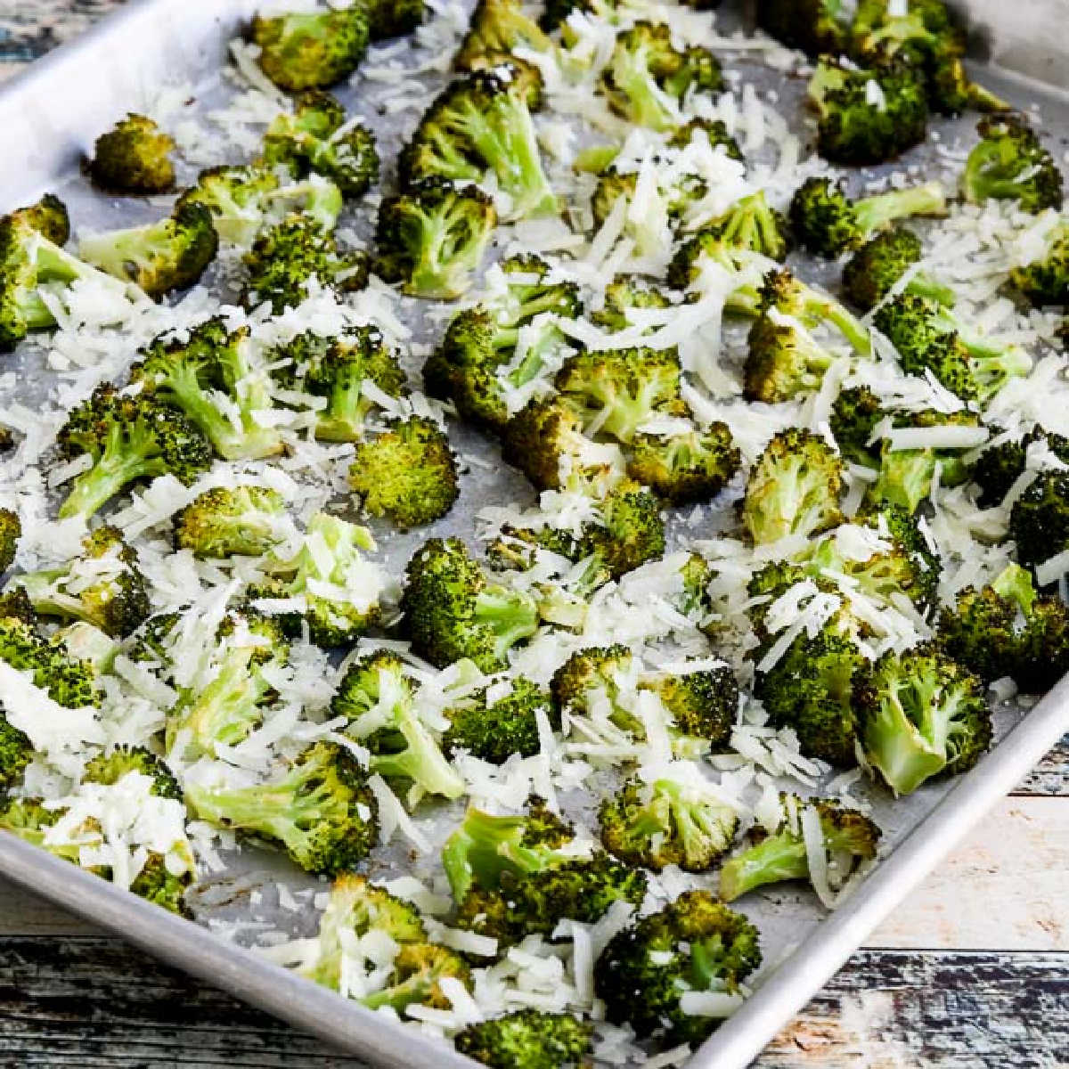 square image of Roasted Broccoli with Lemon and Pecorino-Romano Cheese shown on baking sheet