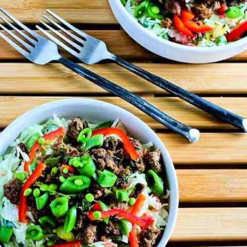 Square image for Sriracha Beef Cabbage Bowls shown in two bowls with forks.