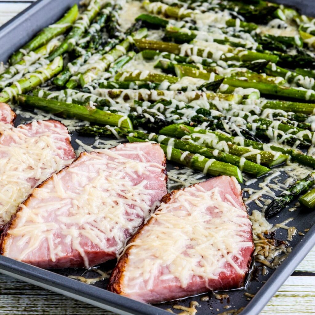 square image of Easy Baked Pesto Chicken in baking dish on striped napkin